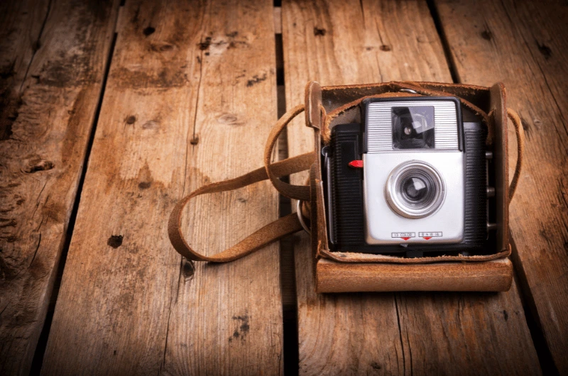 Vintage camera nestled in a classic leather case, showcasing retro design and timeless craftsmanship.