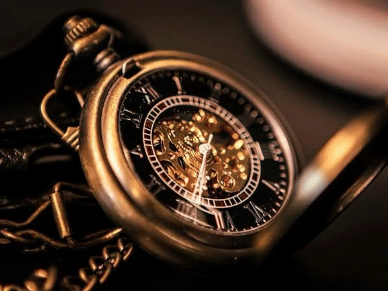 Elegant antique gold pocket watch with intricate detailing, symbolizing timeless craftsmanship and luxury.